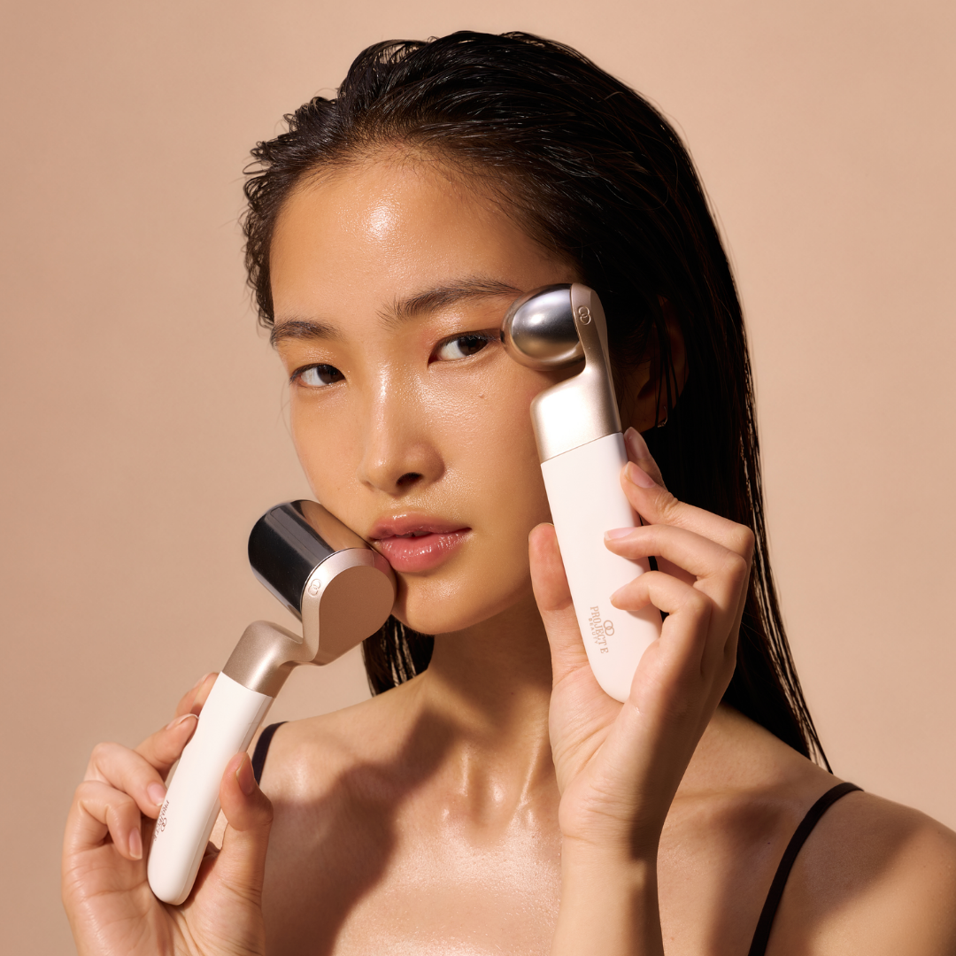 Woman demonstrating cold therapy roller for eye contour and against cheekbone.
