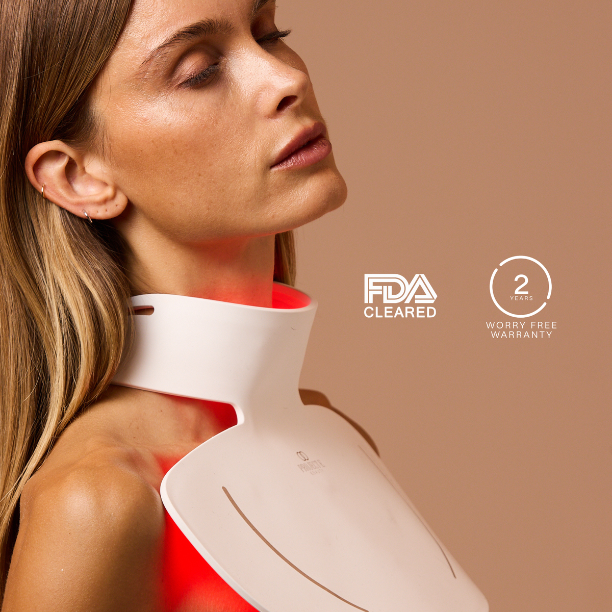 Woman wearing the illuminated LumaLux Face+ V2 neck panel beside regulatory-clearance and warranty badges