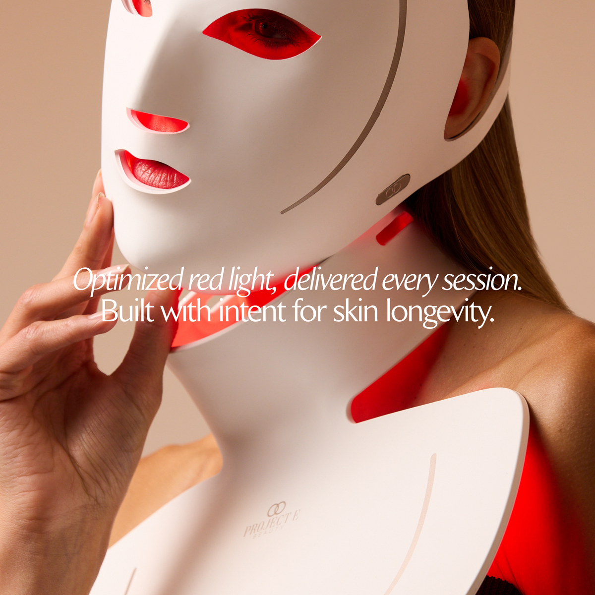 Close-up of a woman wearing the illuminated LumaLux Face+ V2 face and neck mask